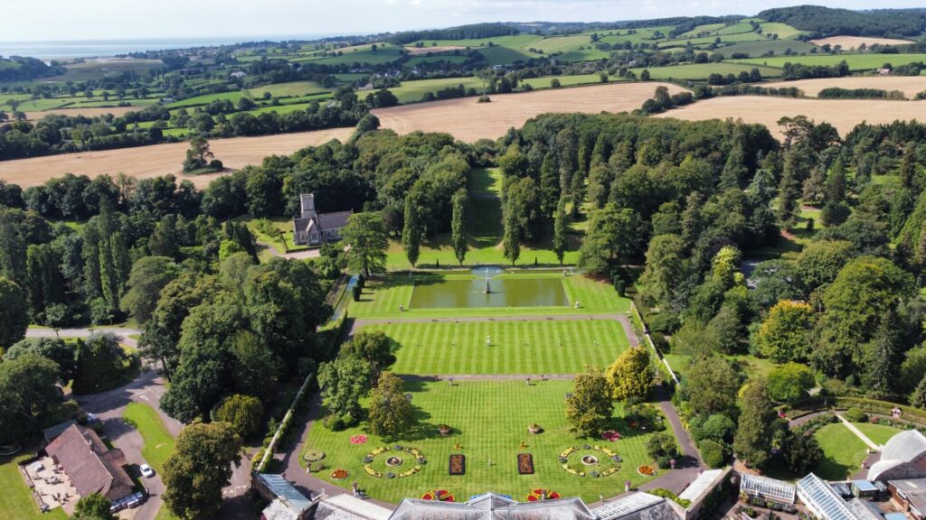 aerial view of manicured gardens lined by trees
